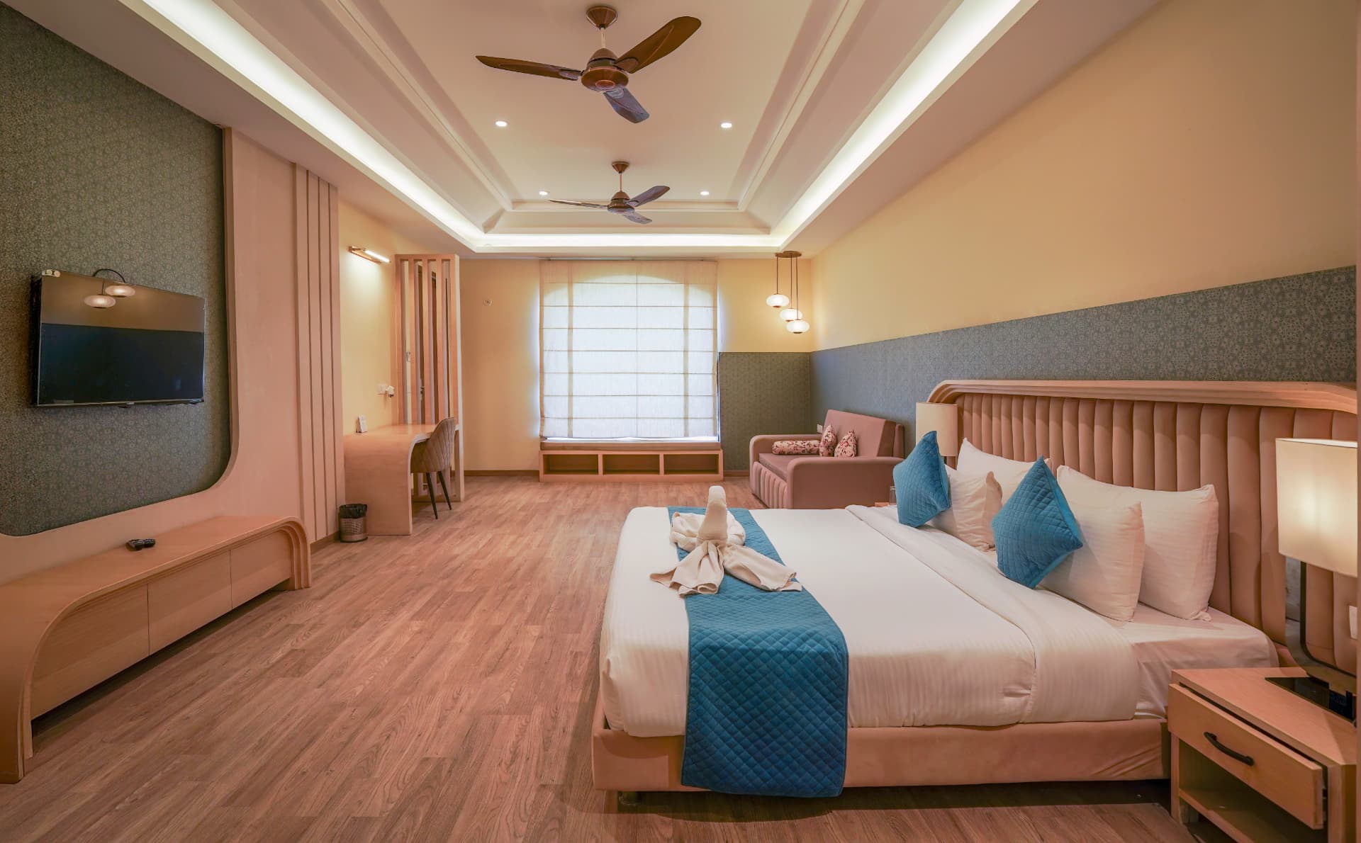 Premium Room wide interior with TV unit, work desk, window seat and king bed at Excel Hotels & Resorts, Kotabagh