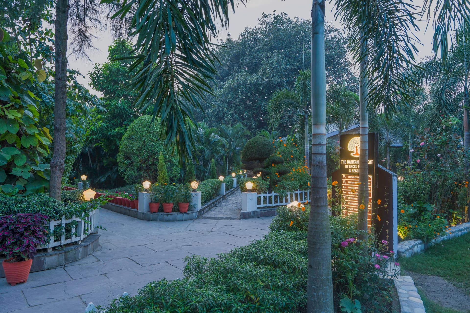 Lamp-lit stone pathway through landscaped gardens at The Banyan Retreat, Jim Corbett