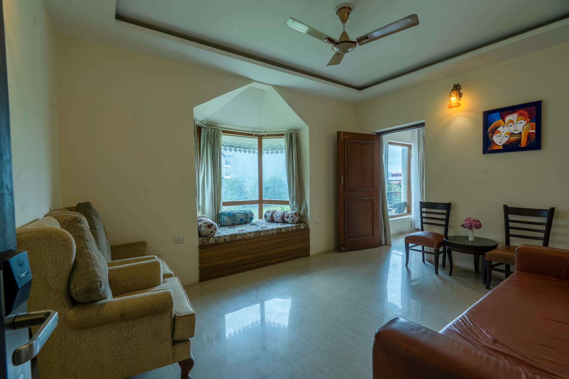 Family Cottage living area with bay window seating and garden views at Excel Hotels & Resorts Bhimtal