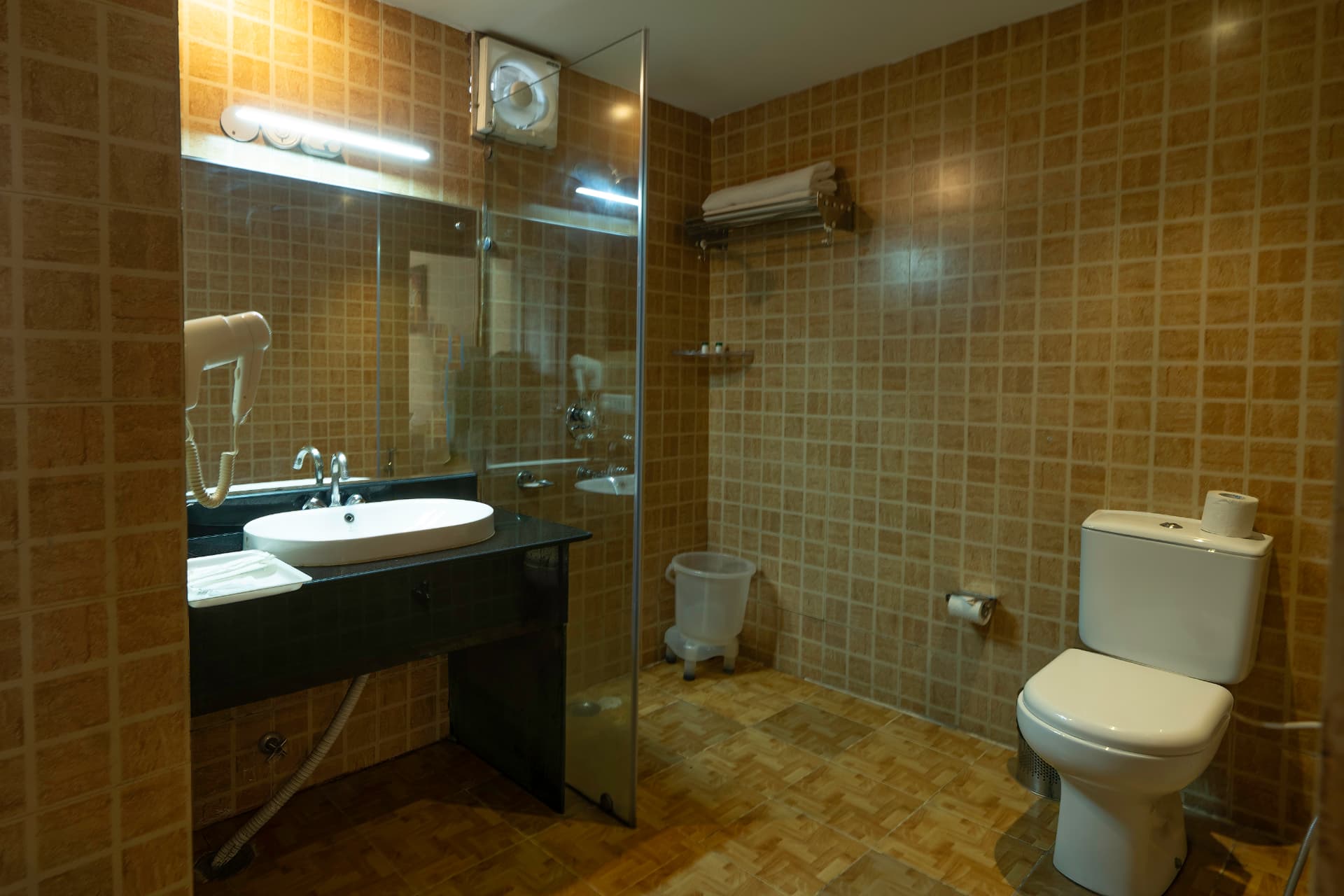 Family Cottage bathroom with vessel sink, shower and modern fittings at Excel Hotels & Resorts Bhimtal