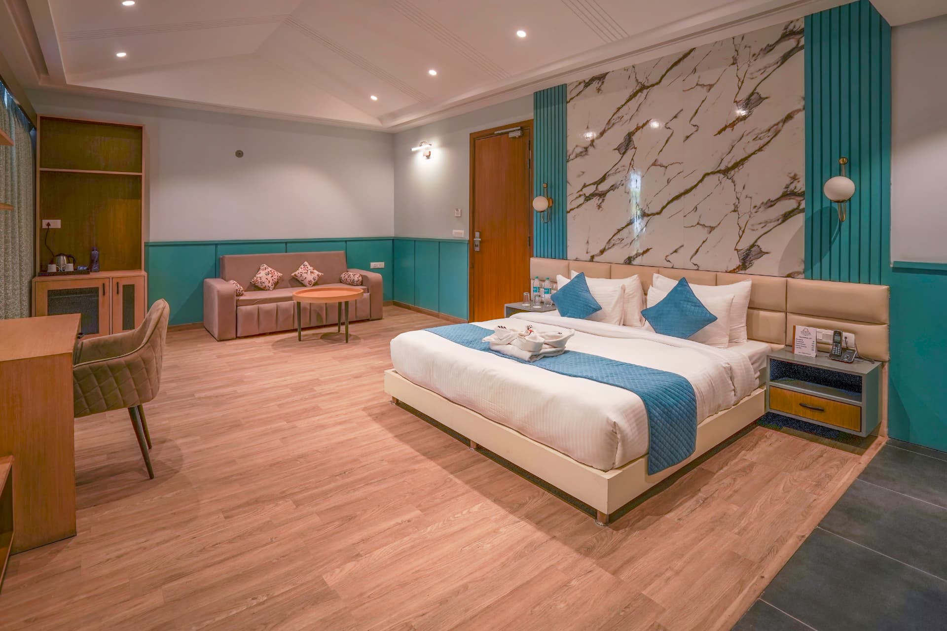 Supreme Room with king bed, teal wainscoting and marble feature wall