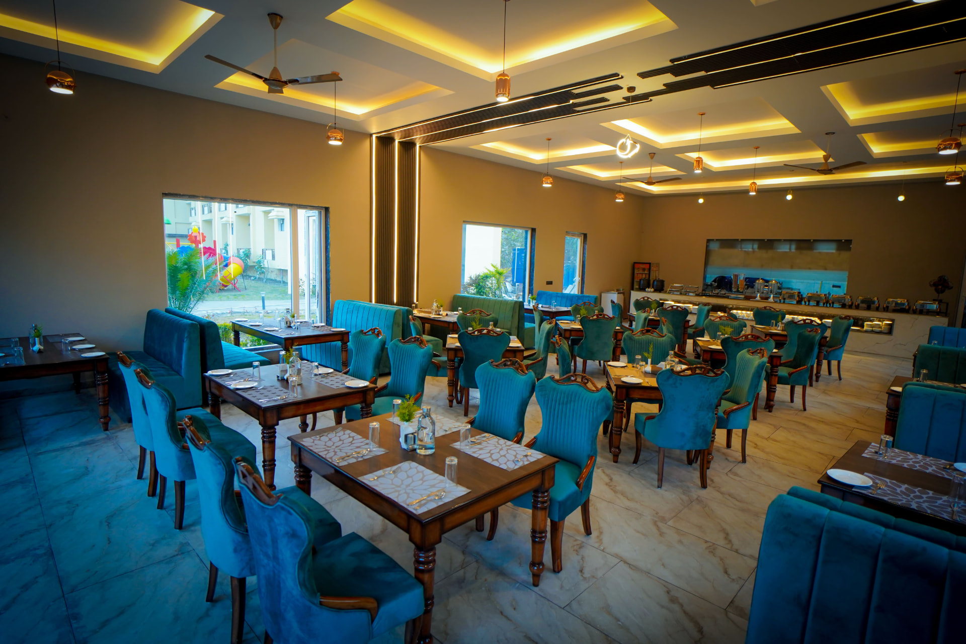 Mango Bloom dining room with teal upholstered chairs