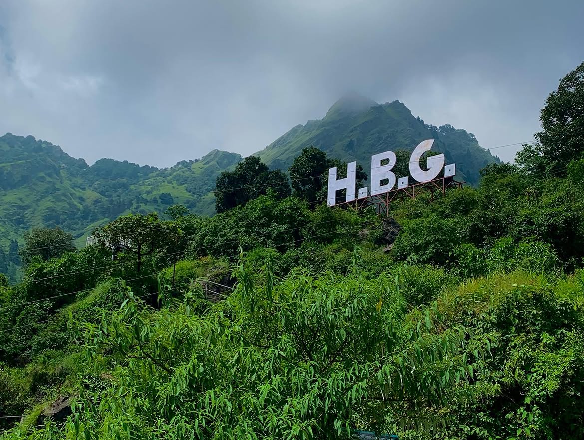 H.B.G. sign on the forested hillside at G.B. Pant High Altitude Zoo, Nainital