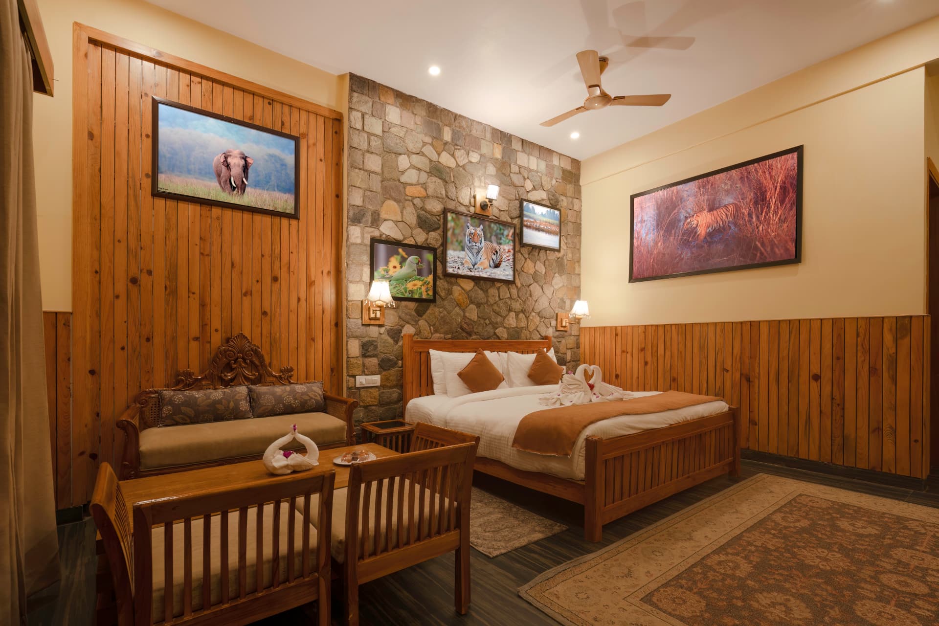 Wooden armchair and stone feature wall inside the Banyan Tree with Banyan View room at The Banyan Retreat Corbett