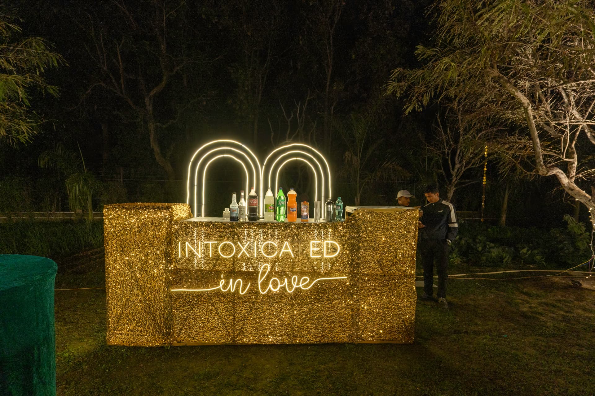 Golden glitter wedding bar counter with neon lighting at Excel Hotels & Resorts, Corbett