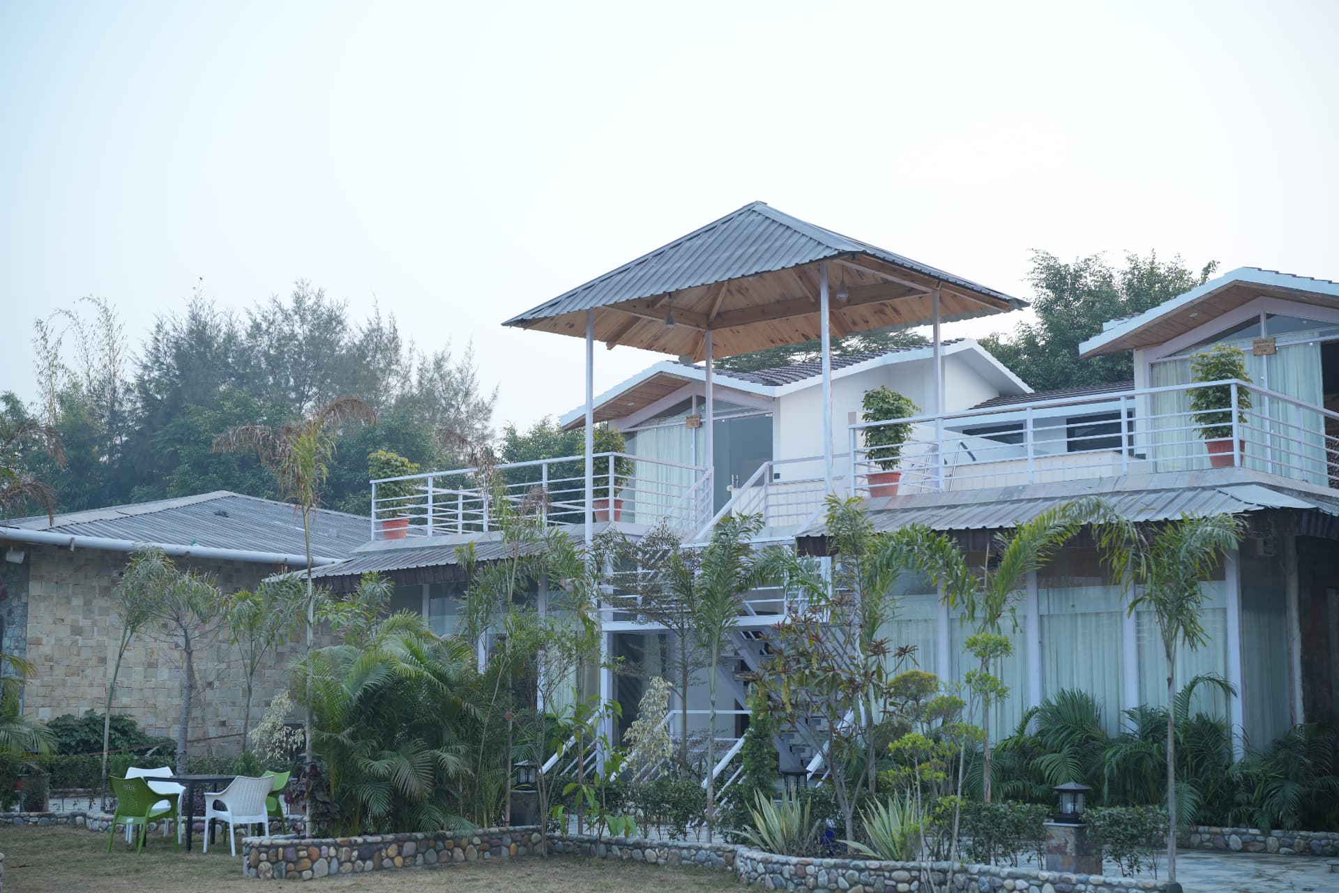 The Banyan Retreat Corbett — resort cottages and landscaped garden exterior