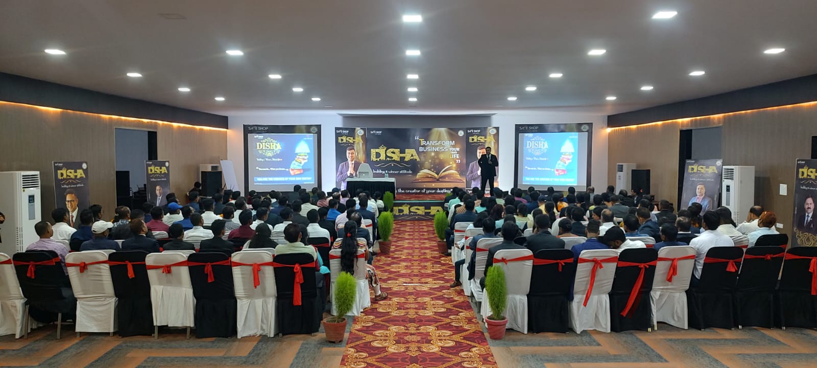 Corporate presentation with stage and screens at The Banyan Retreat