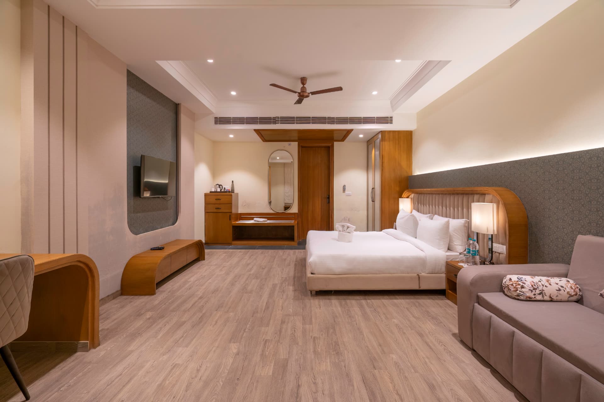 Premium Room wide view with TV unit, dressing area, king bed and soft seating at Excel Hotels & Resorts, Kotabagh