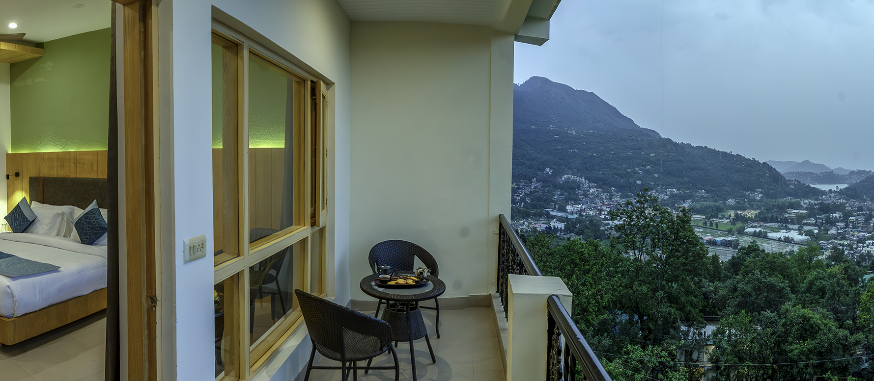 Private Premium Room balcony with seating and panoramic mountain views in Bhimtal