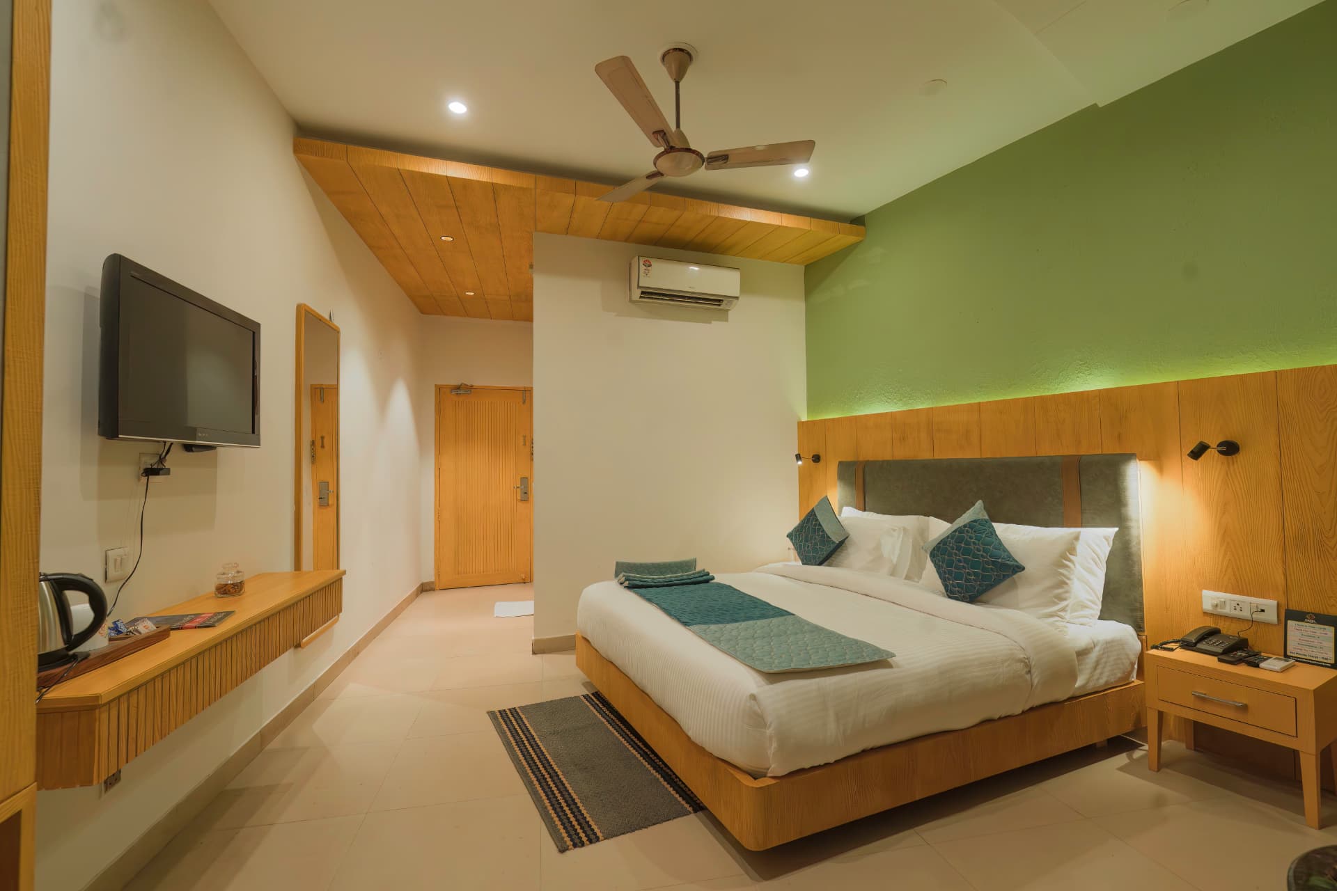 Premium Room interior with wooden finishes at Excel Hotels Bhimtal