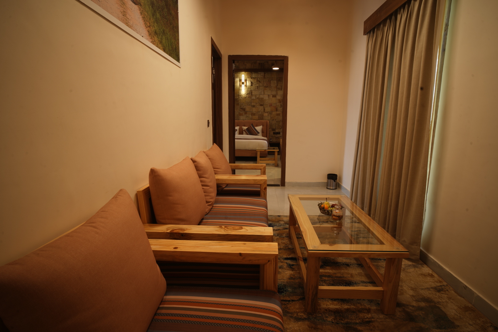 Banyan Suite at The Banyan Retreat Corbett — lounge seating with glass coffee table opening to the bedroom