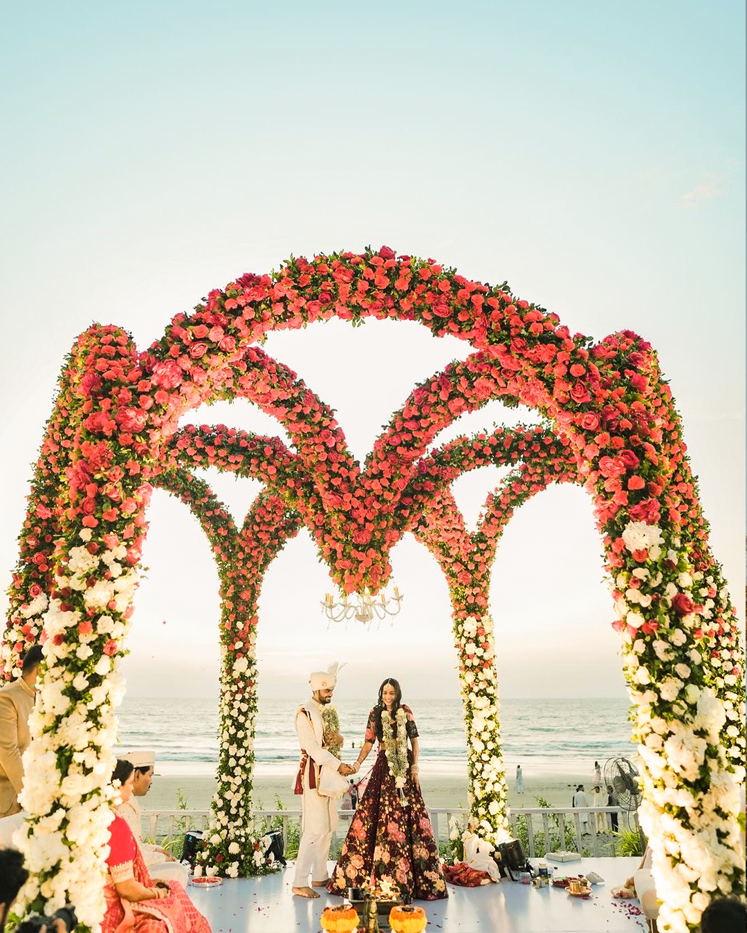 Varmala stage framed by a rose and greenery arch at La Perle River Resort, Jim Corbett
