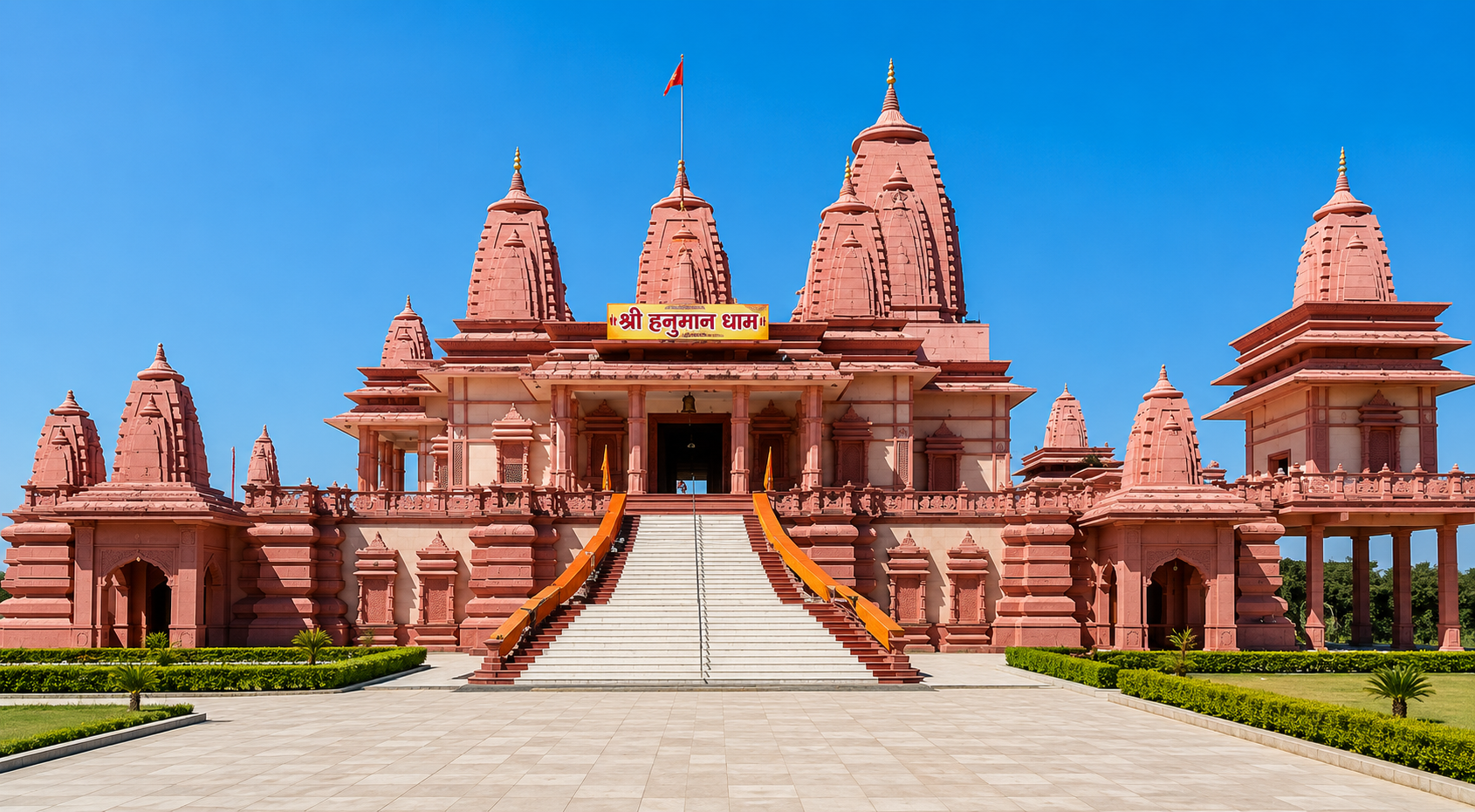 Hanuman Dham temple complex in daylight showcasing pink sandstone architecture and central staircase, Jim Corbett