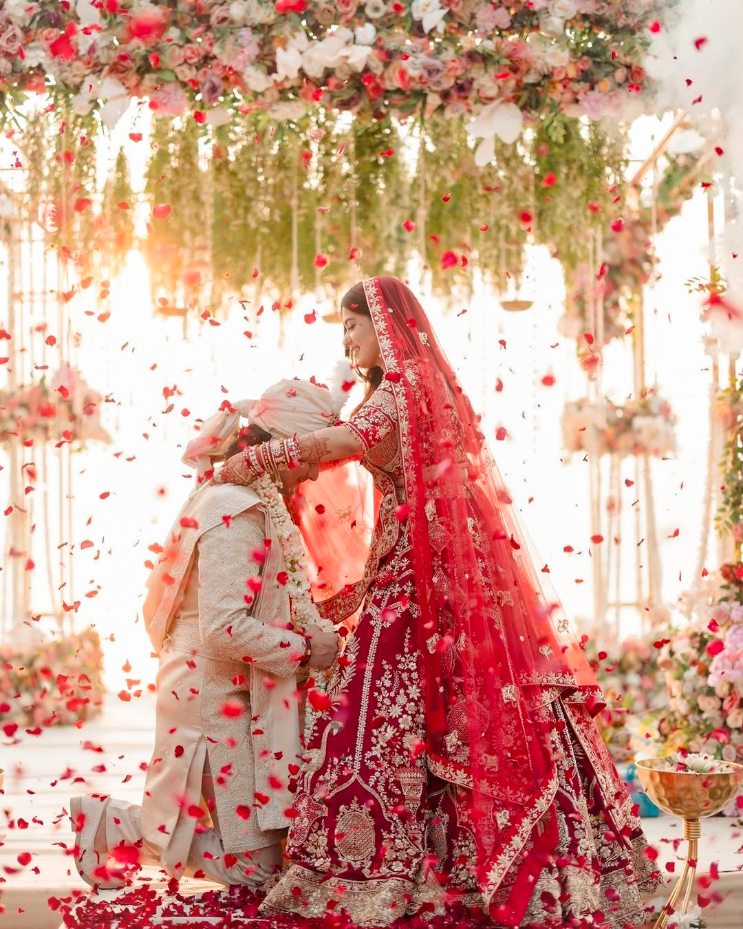 Bride and groom during the Pheraas amid a shower of rose petals at La Perle River Resort