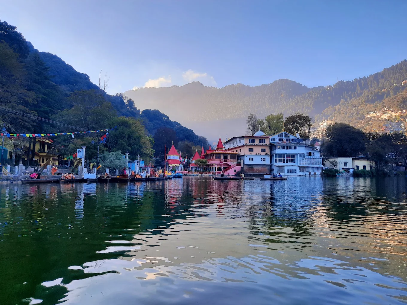 Wide view of Naini Lake with the Naina Devi Temple complex and Nainital hills behind