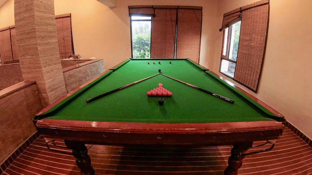 Main swimming pool surrounded by forest at The Banyan Retreat