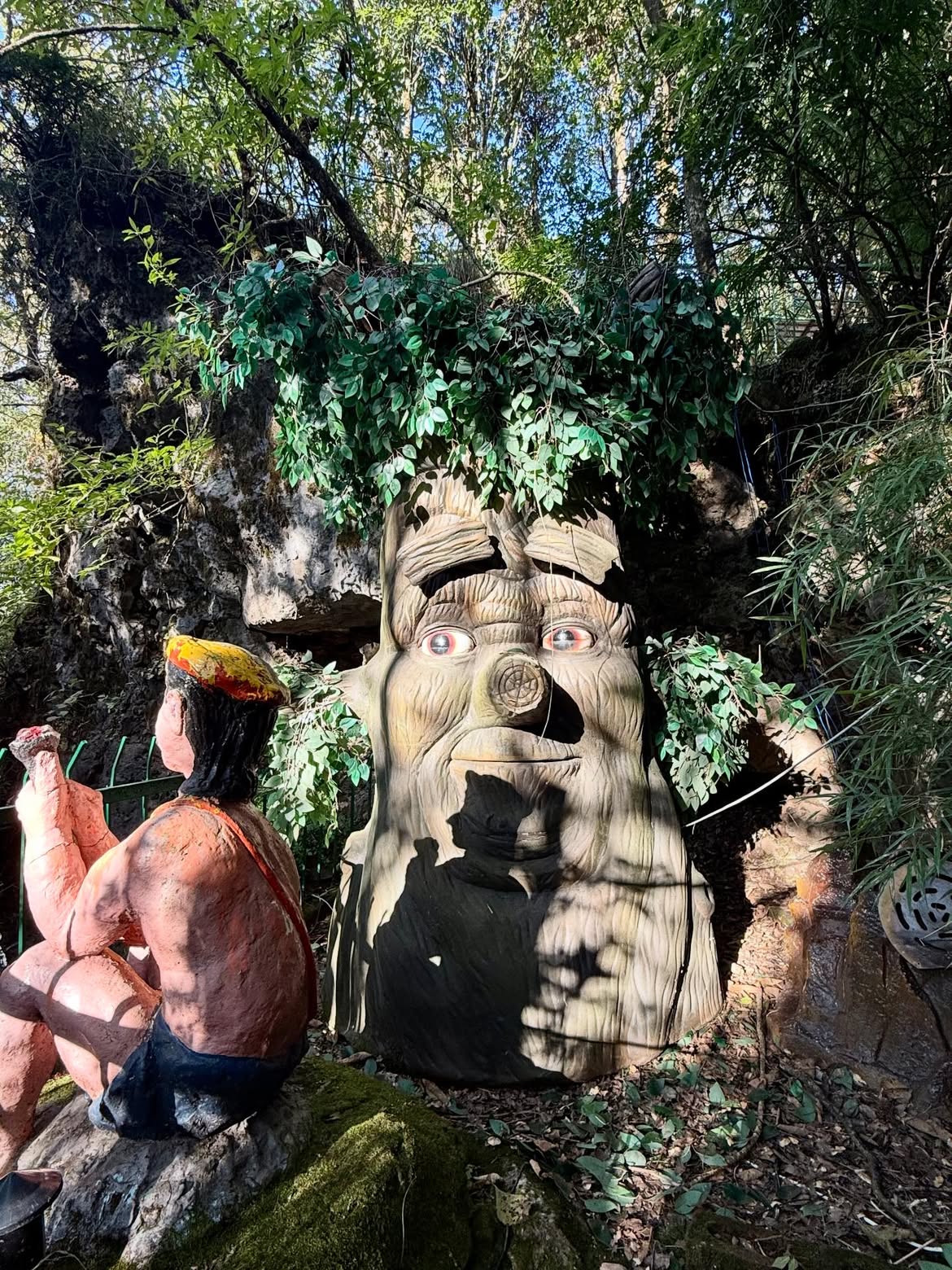 Talking Tree sculpture and themed figures along the Cave Garden trail
