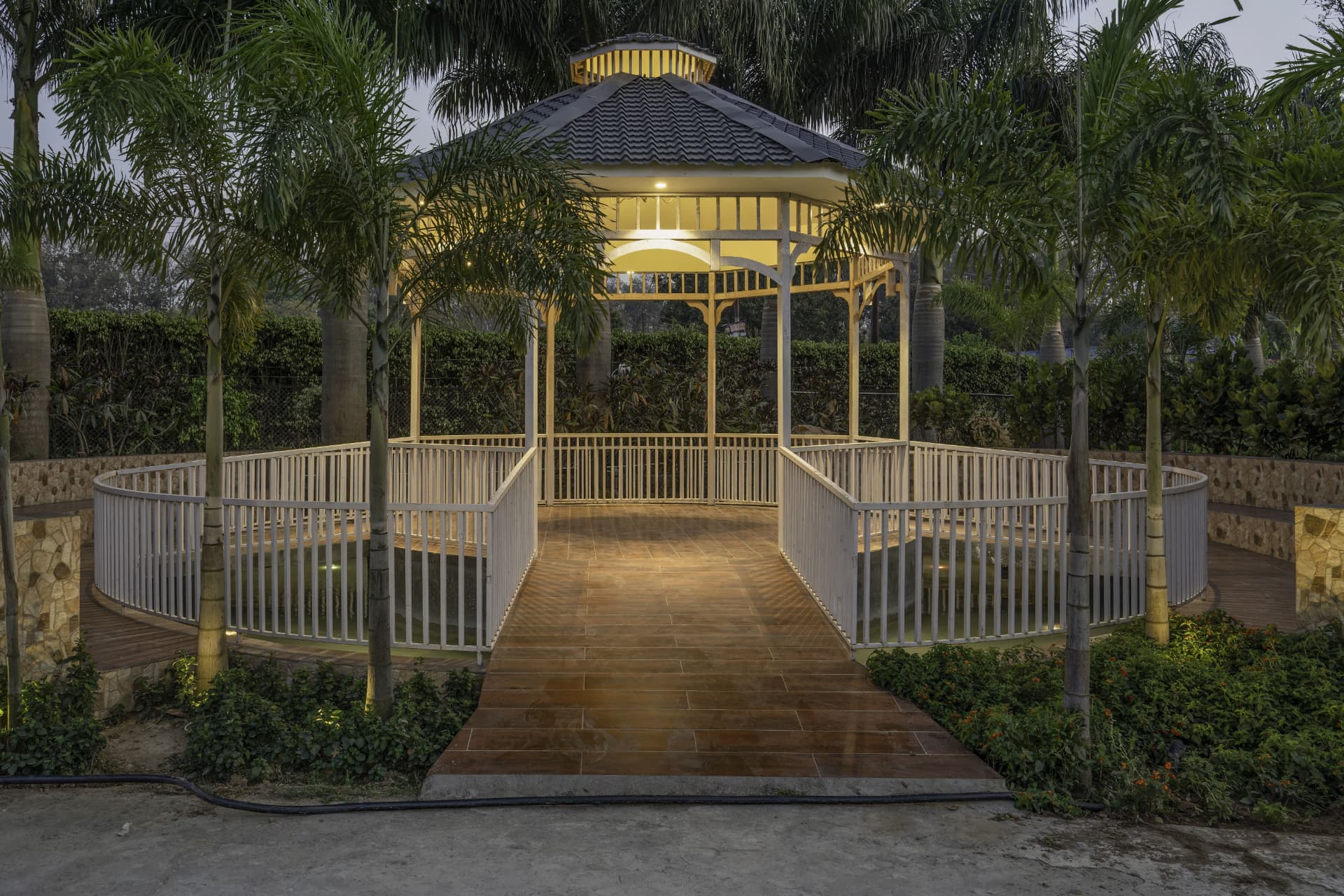 Illuminated garden gazebo over a water feature at Excel Hotels & Resorts, Kotabagh