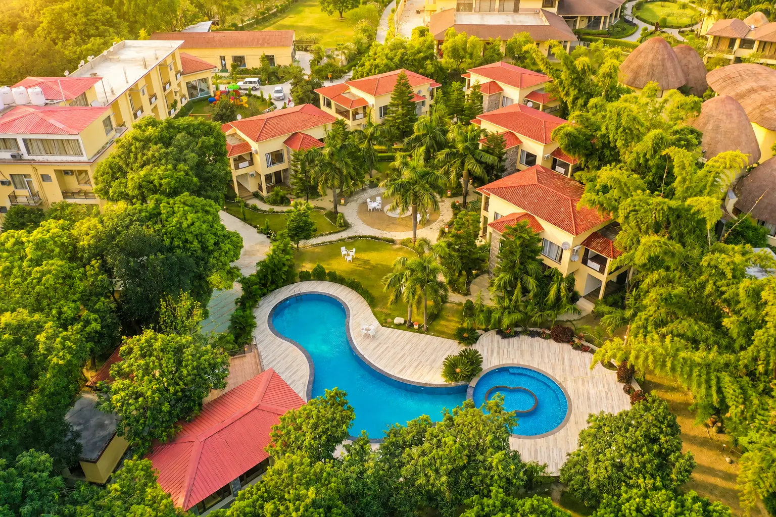 Aerial view of the pool, villas and gardens at Mango Bloom River Resort