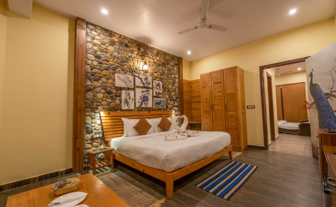 Pilkhan Suite pebble-stone wall interior and peacock-themed door at The Banyan Retreat