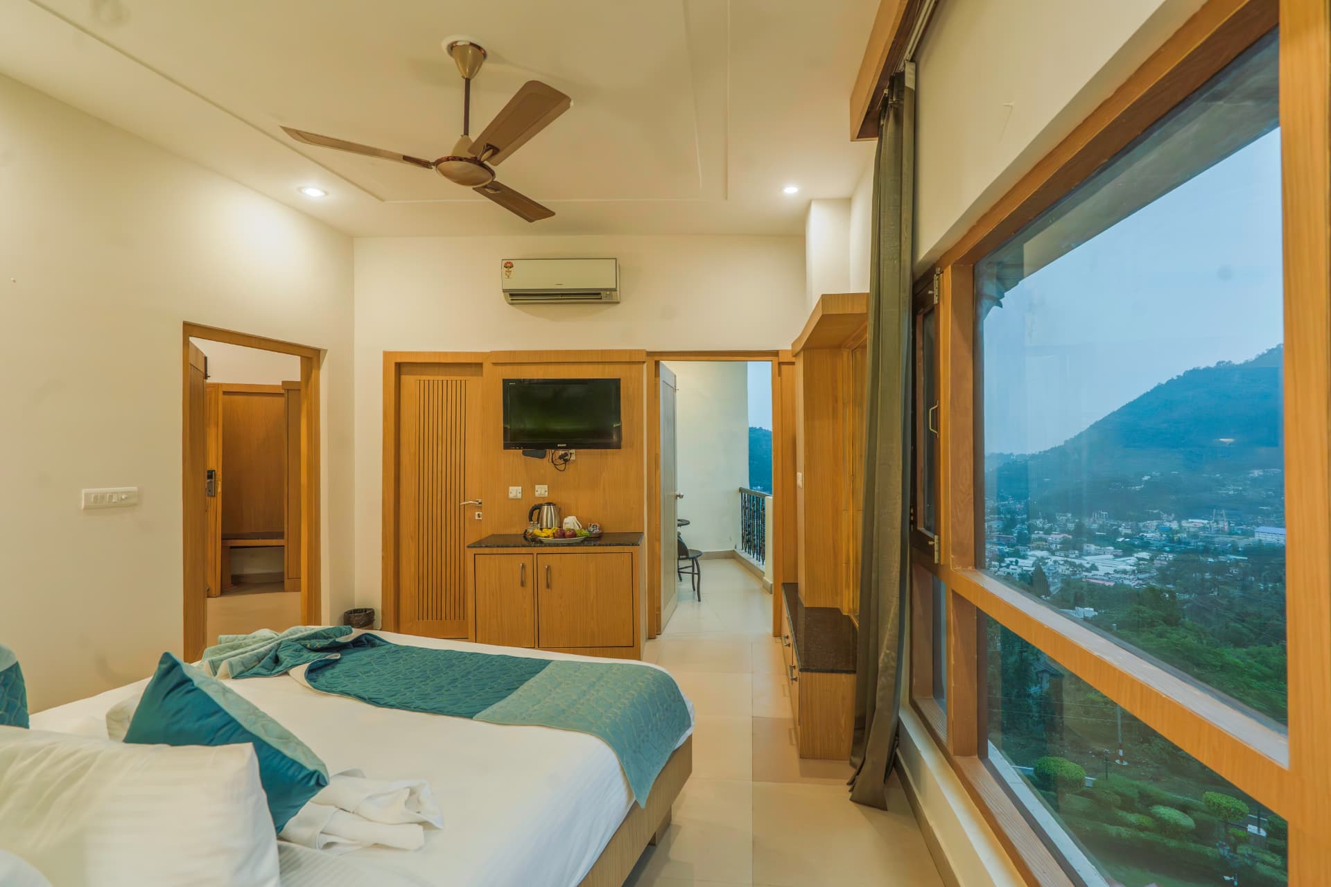 Premium Room balcony overlooking the town and hills at Excel Hotels Bhimtal