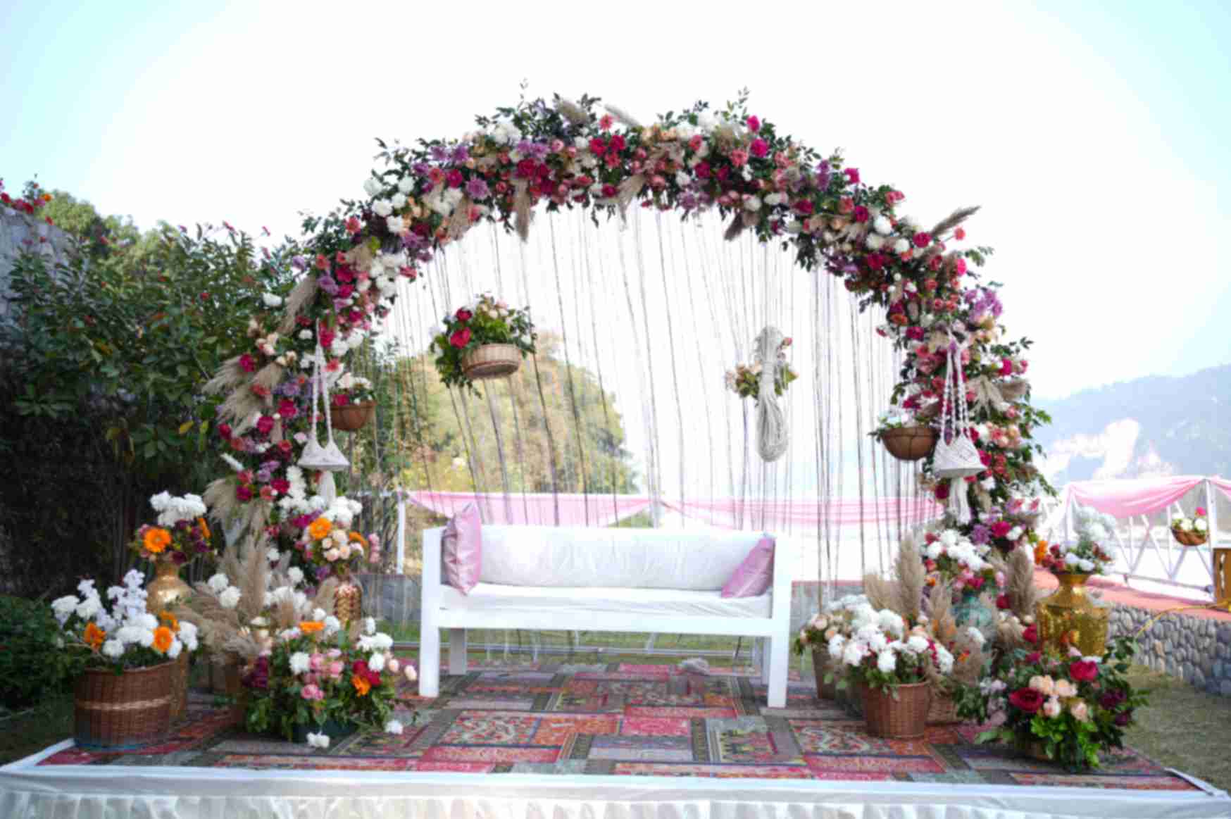 Flower-covered swing and seating at La Perle River Resort