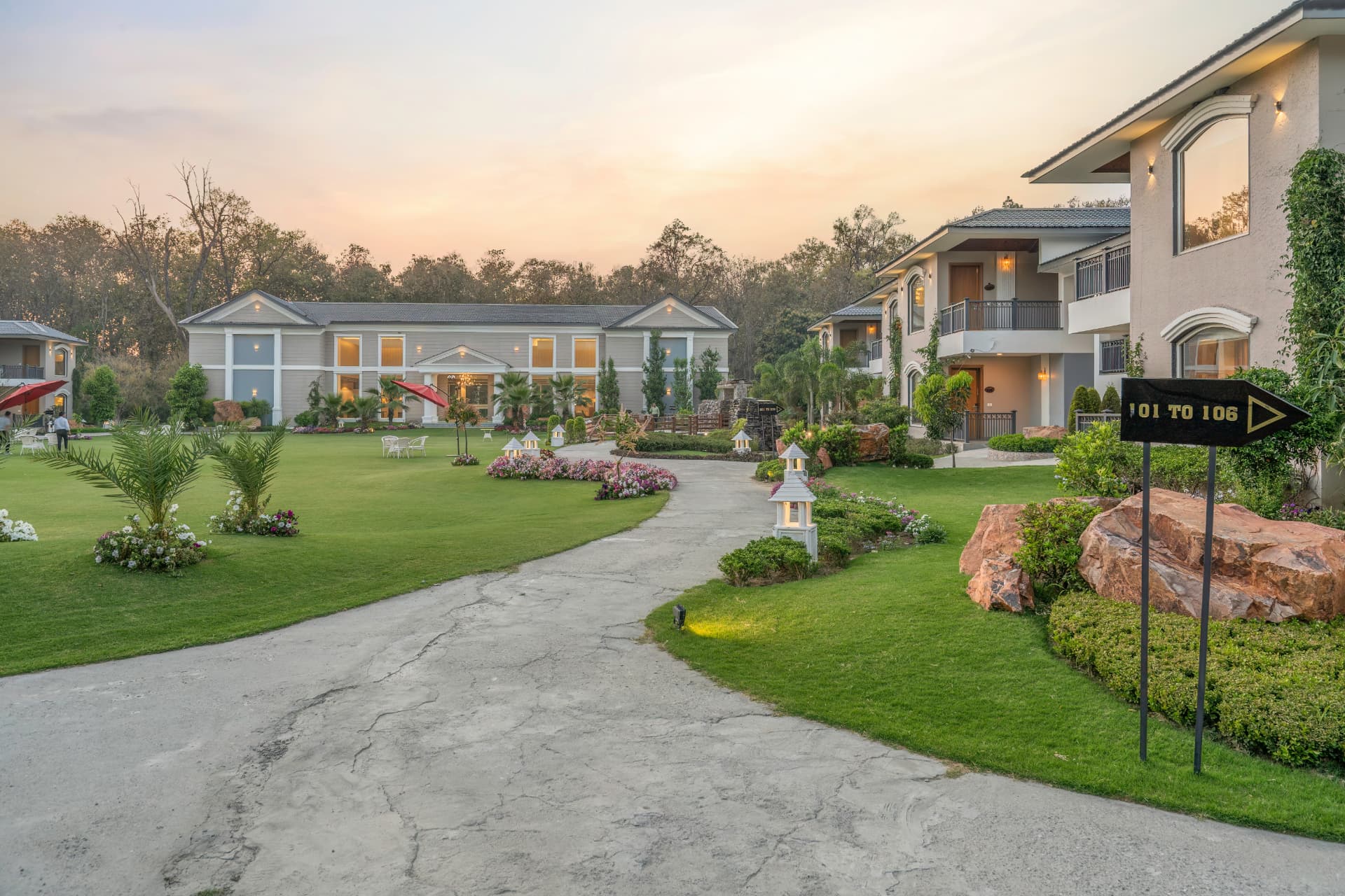 Landscaped pathways and lawns at sunset at Excel Hotels & Resorts, Kotabagh