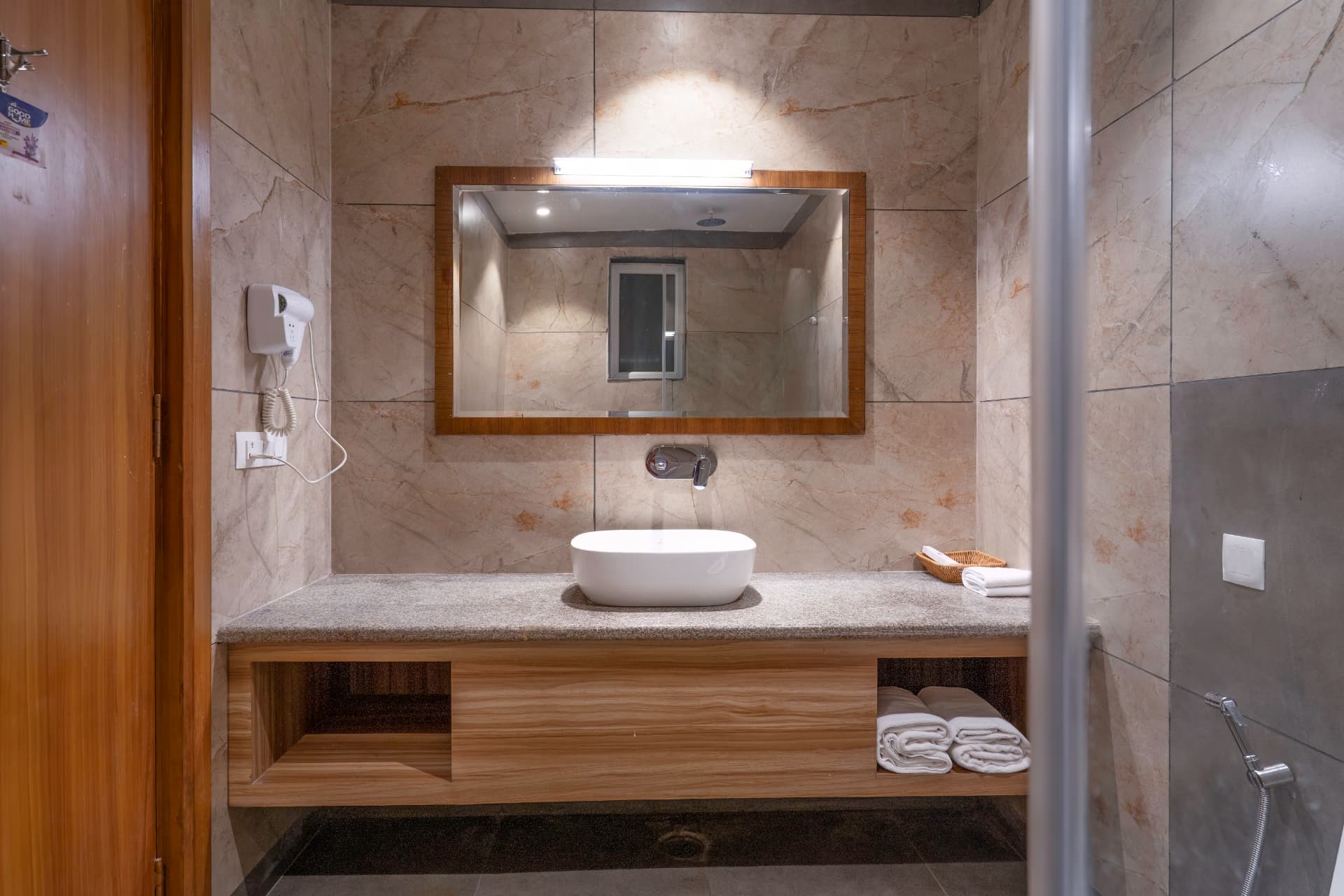 Premium Room bathroom with marble-style tiles, vessel sink, mirror and fresh towels at Excel Hotels & Resorts, Kotabagh
