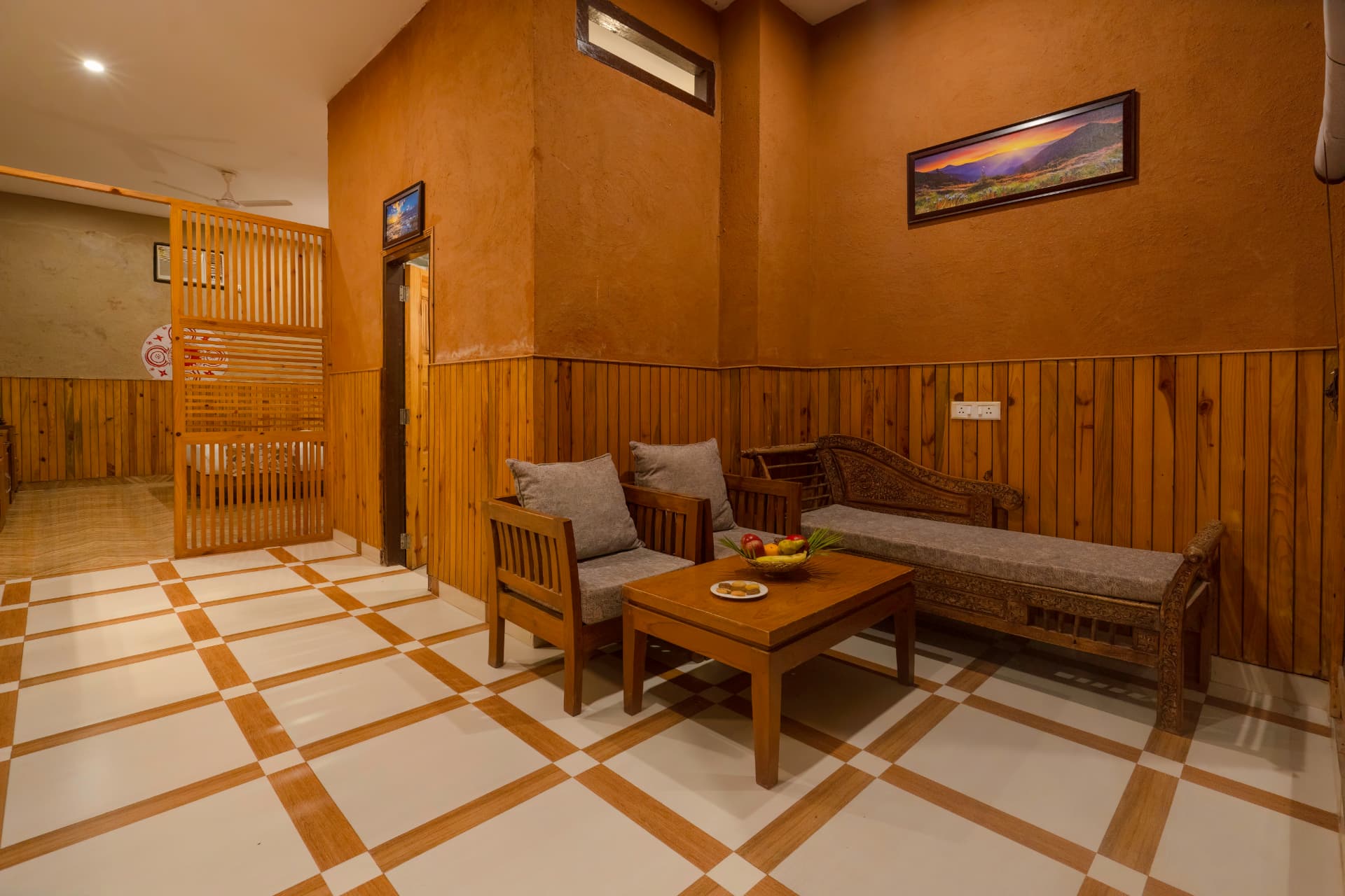 Seating lounge with carved daybed at Banyan Gaon