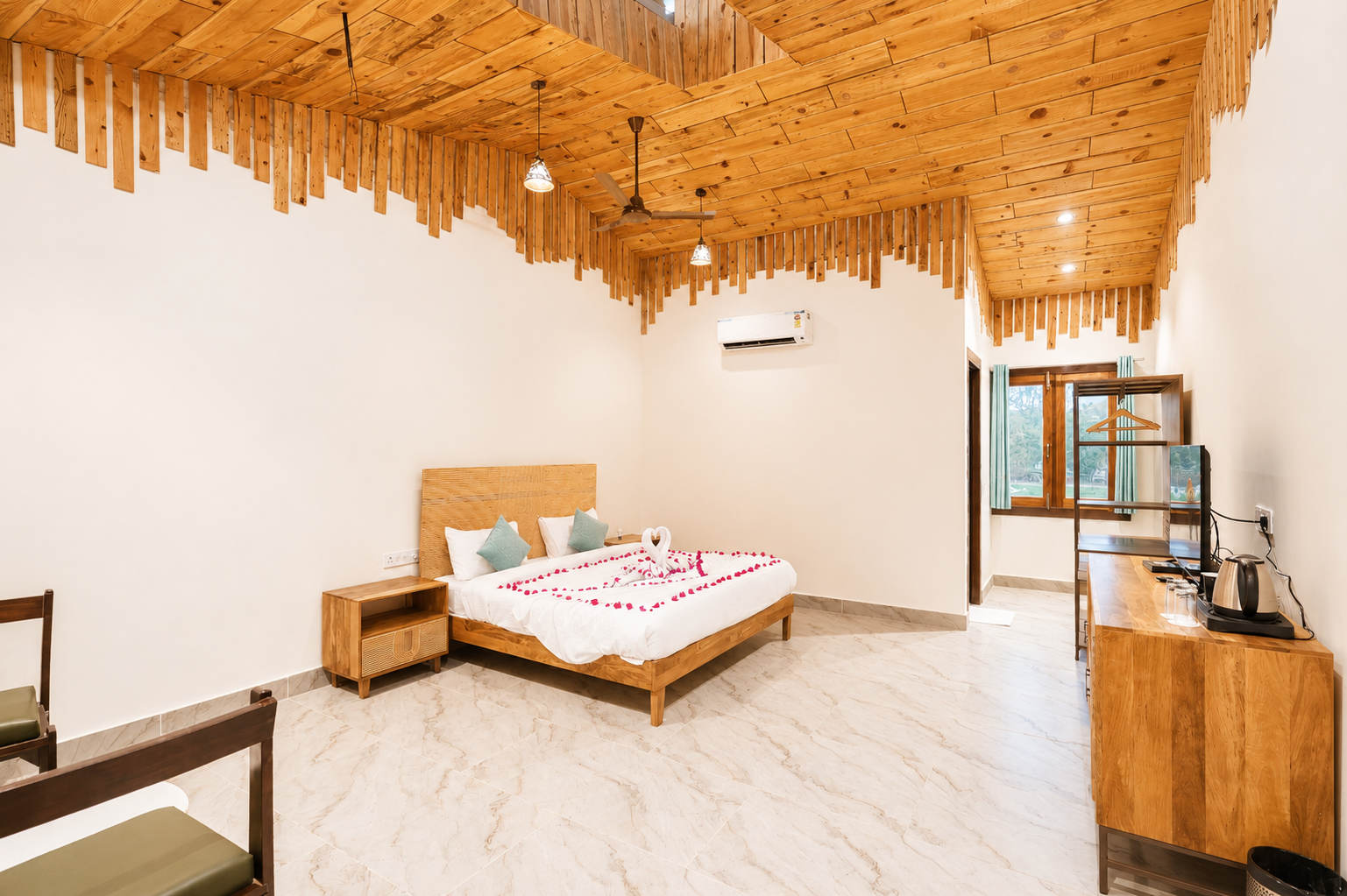 King-size bed and warm interiors of the Cotton Tree Superior at La Perle River Resort