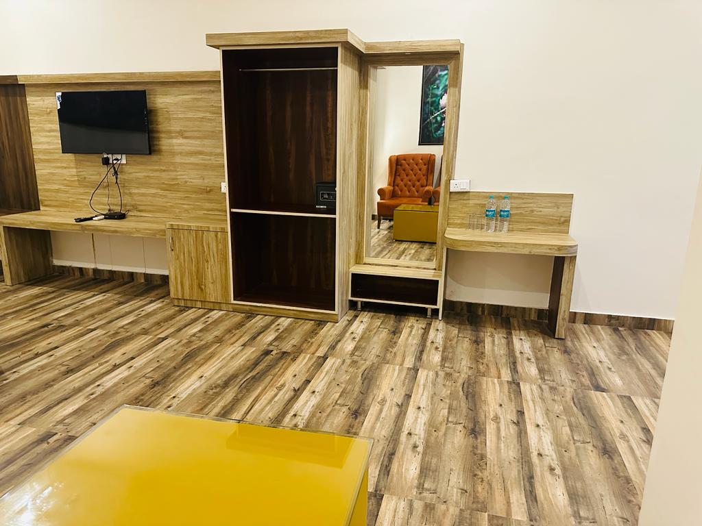 Kosi Retreat room wardrobe, TV console and work desk area at The Banyan Retreat