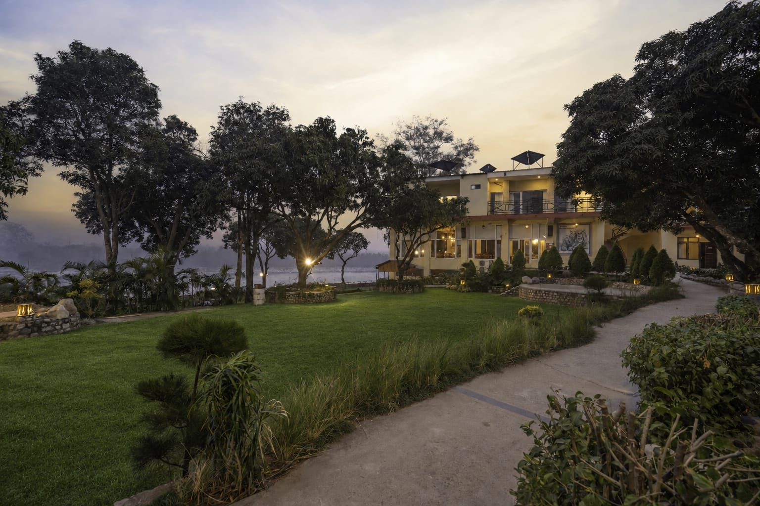 Riverside Lawn at dusk with lawn and river view at La Perle River Resort