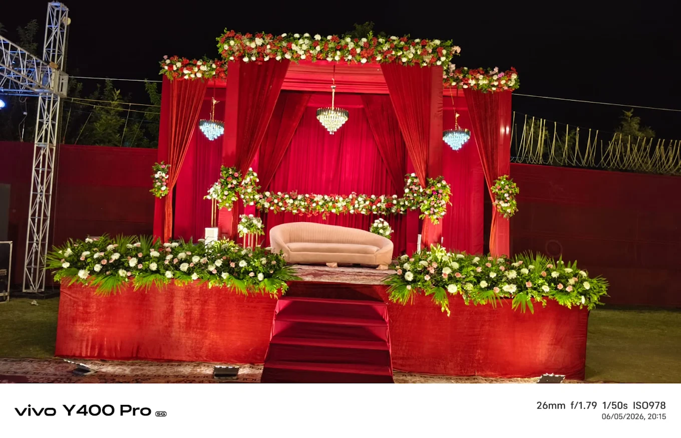Red draped floral wedding stage in the Emerald Pavilion Hall at Excel Hotels & Resorts, Bhimtal