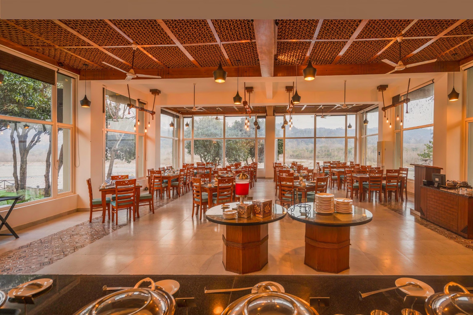 Candlelit riverside dining setting at an Excel resort in Uttarakhand