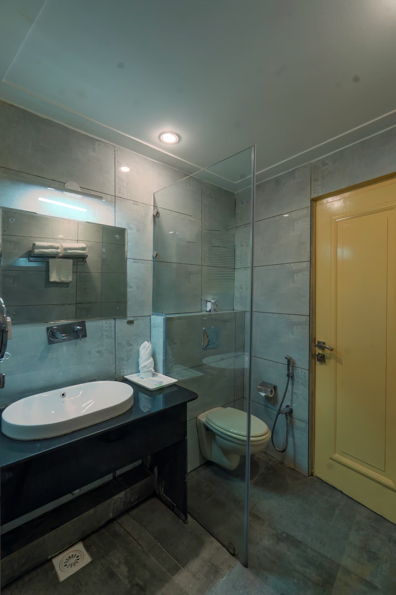 Premium Room bathroom with glass shower, vessel sink and modern fittings at Excel Hotels Bhimtal