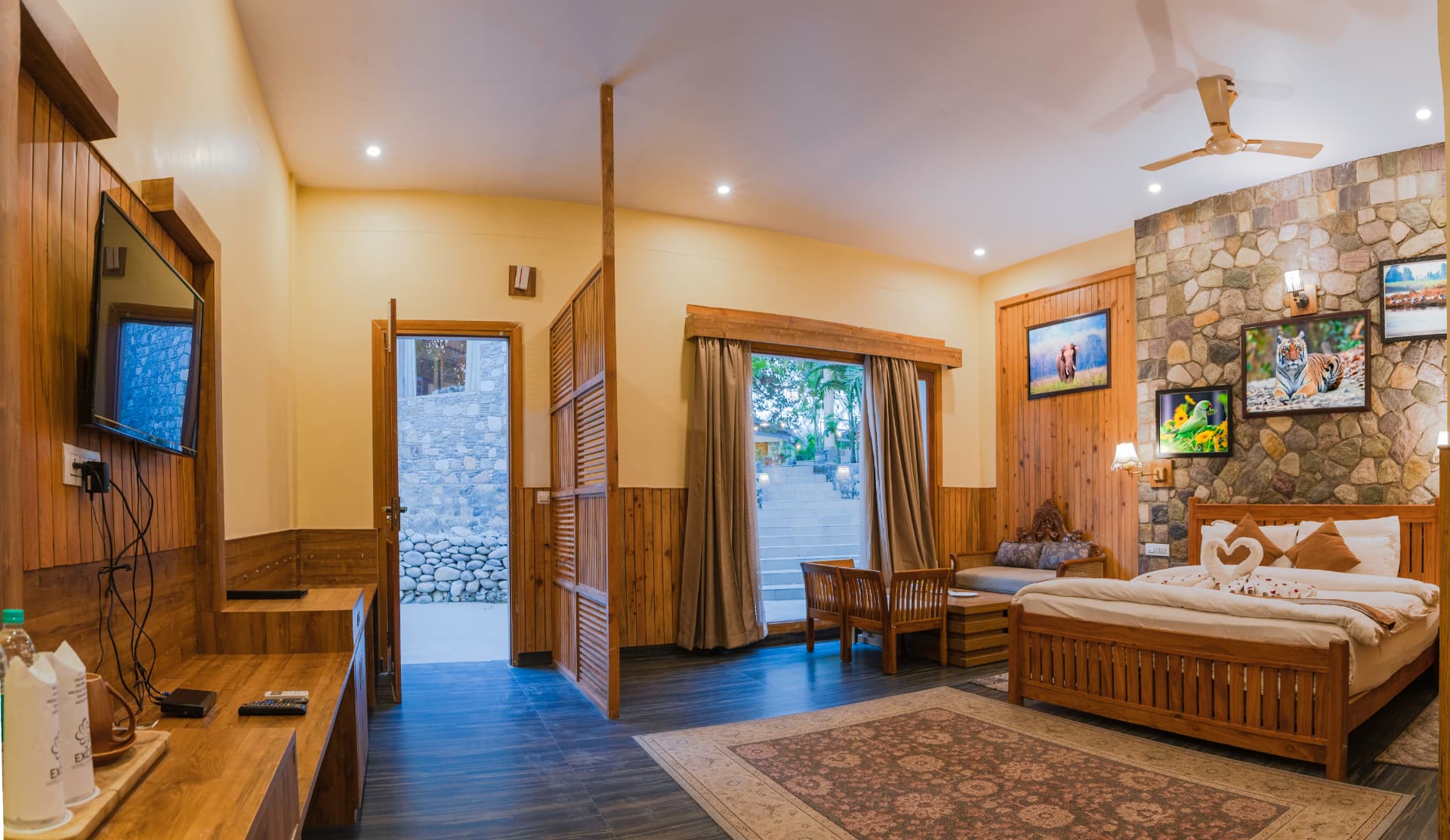 LED TV, wooden console and private entry inside the Banyan Tree with Banyan View room at The Banyan Retreat Corbett