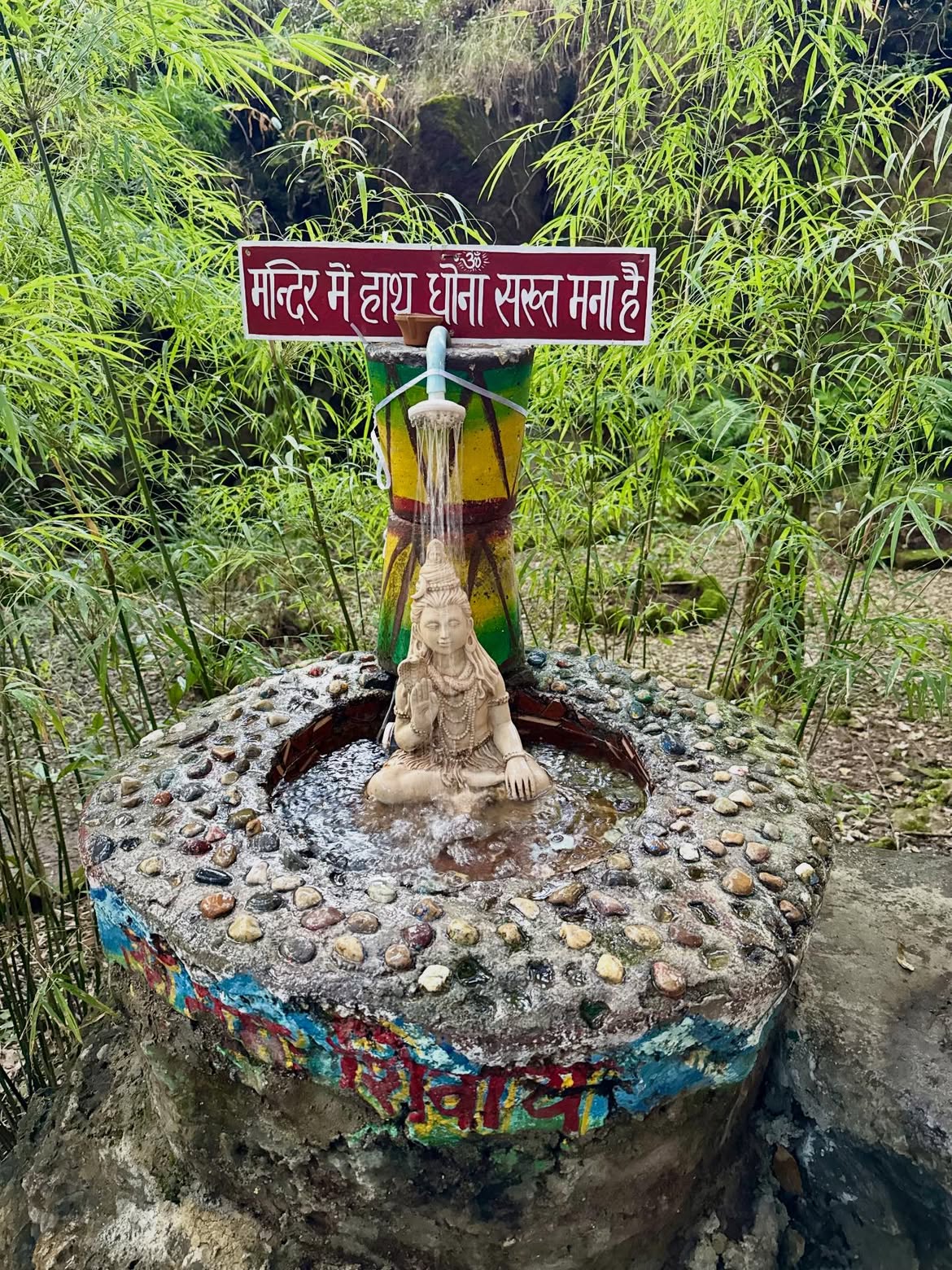 Lord Shiva statue with a small fountain inside Cave Garden, Nainital