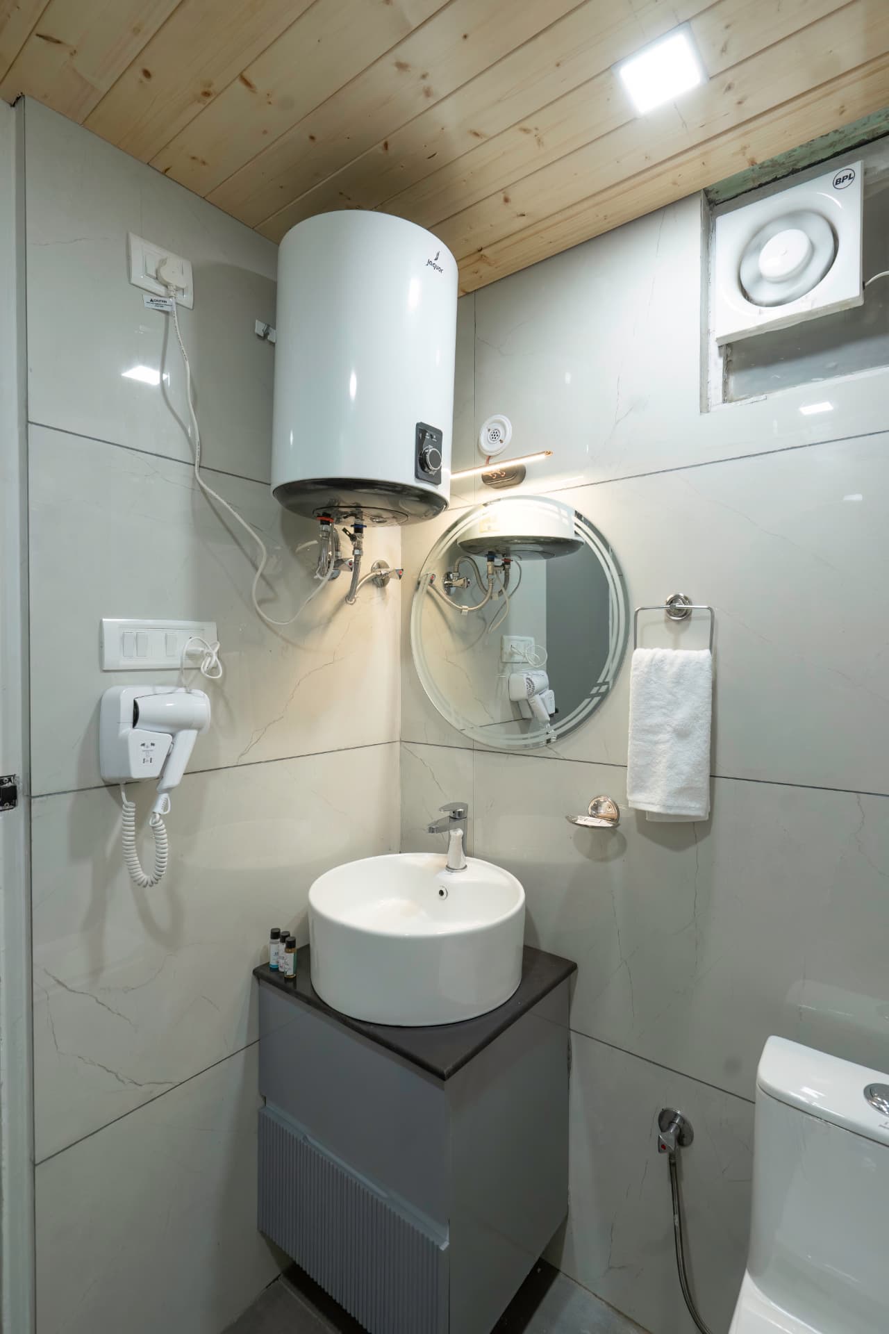 Modern bathroom with geyser, vessel sink and premium fittings in Deluxe Lake View Room