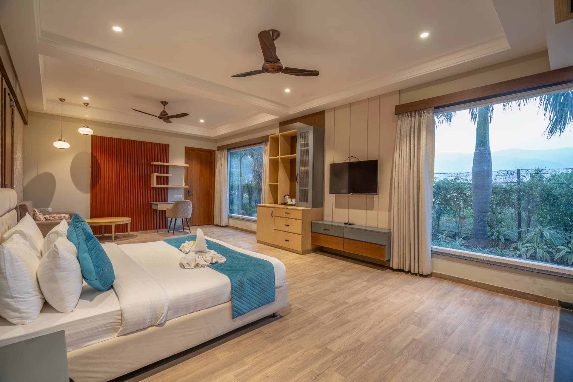 Supreme Room with garden view, king bed and wood-panelled desk area