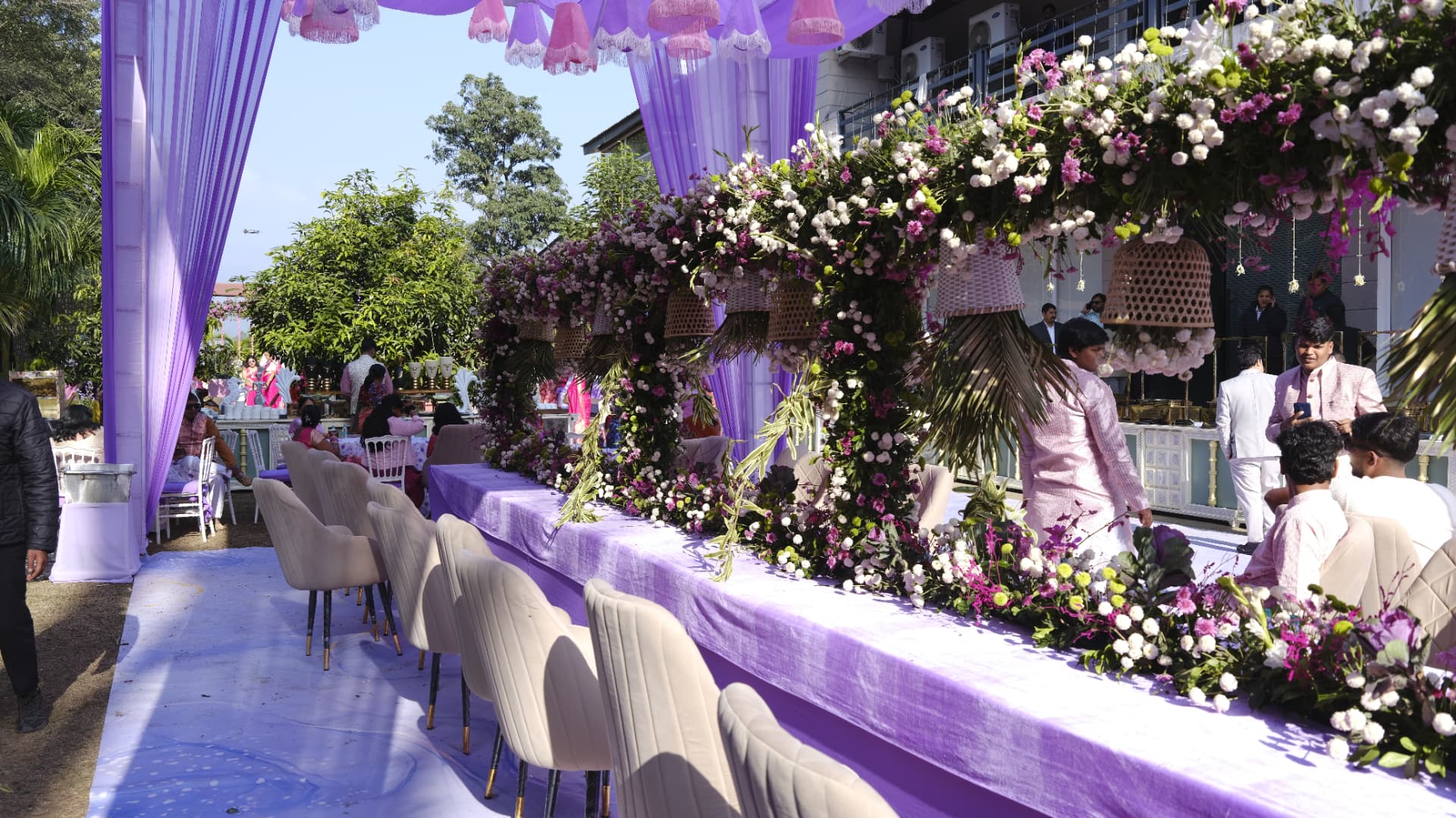 Lavender and floral Mehndi décor with long guest table at La Perle River Resort