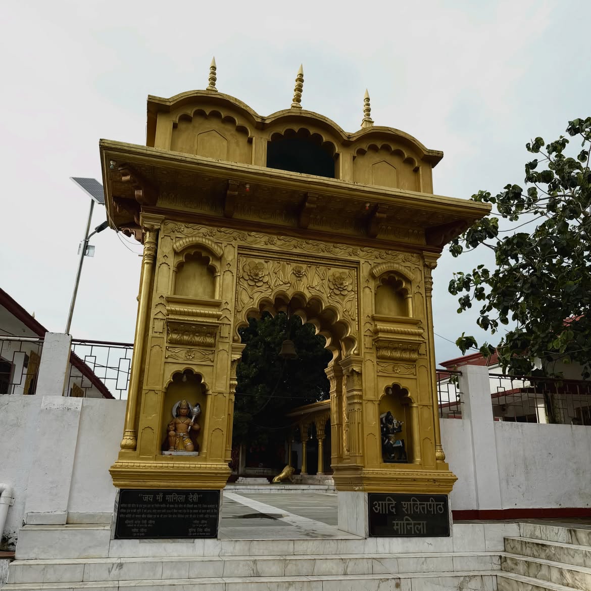 Golden carved entrance gate of Manila Devi Temple in Uttarakhand