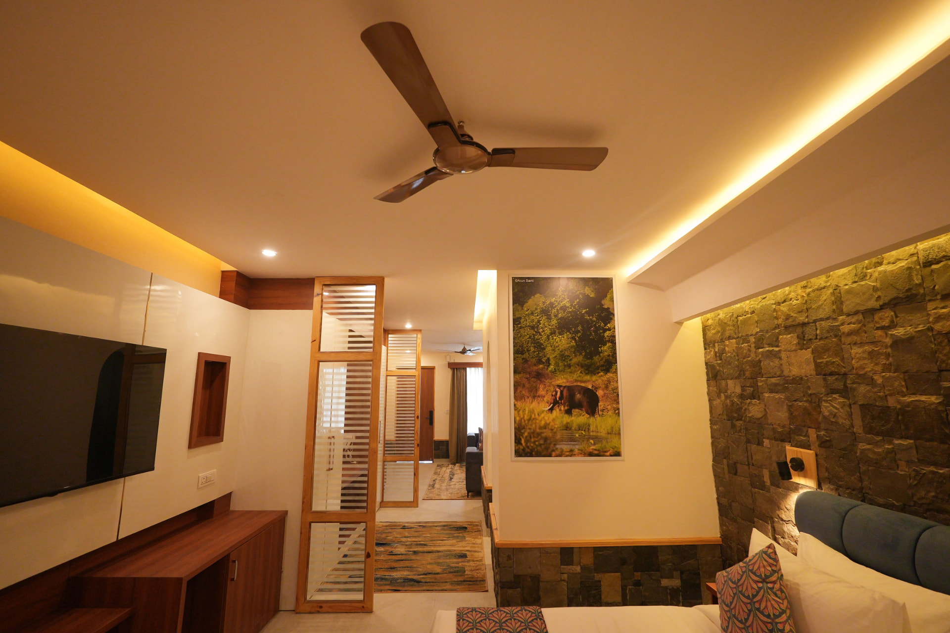 Sunbird Suite wood-panelled TV wall, wildlife artwork and timber partition in Jim Corbett