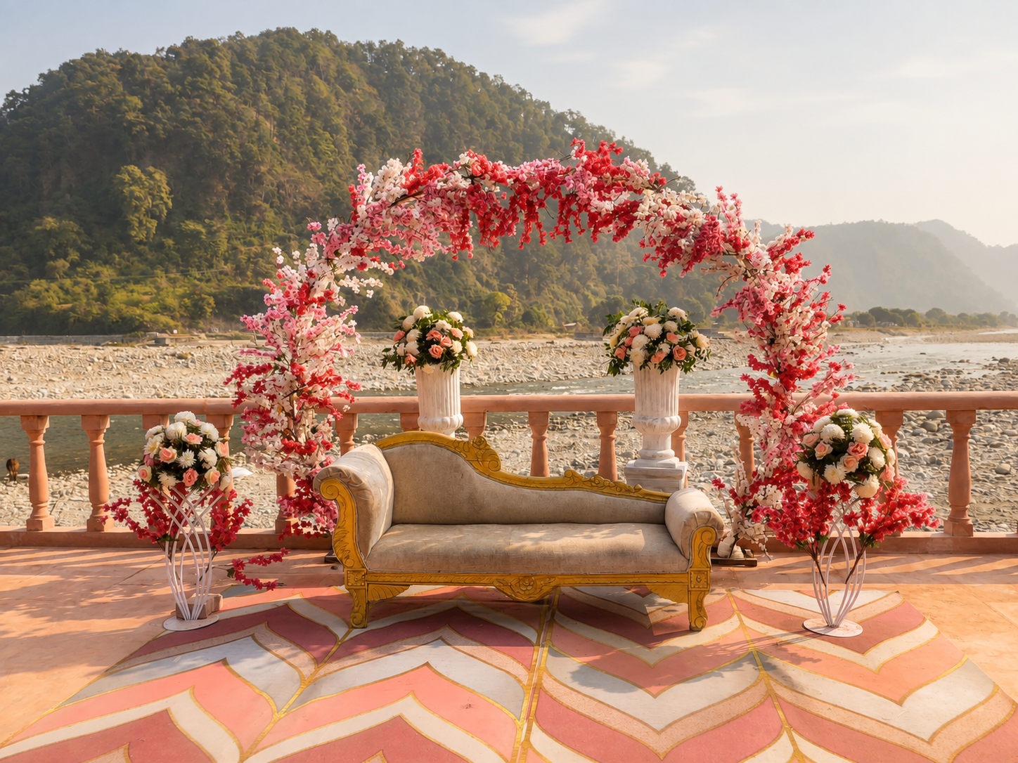 Floral wedding sofa and flower arch décor on the riverside terrace at Mango Bloom
